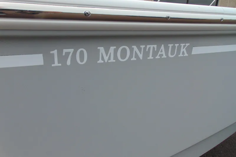 Slide: The Image of 2026 Boston Whaler 170 Montauk boat side view with model name displayed. - 5
