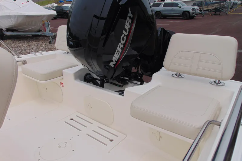 Slide: The Image of 2026 Boston Whaler 170 Montauk boat interior with Mercury engine and cushioned seating. - 7