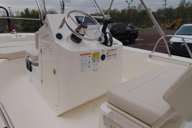 Slide: The Image of 2026 Boston Whaler 170 Montauk boat interior with steering console and seating. - 8