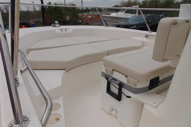 Slide: The Image of 2026 Boston Whaler 170 Montauk boat interior with cushioned seating and railing. - 9