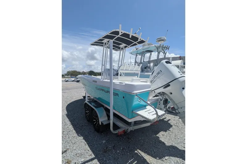 Slide: The Image of 2026 Clearwater 2000 Center Console boat on trailer, parked outdoors under blue sky. - 3