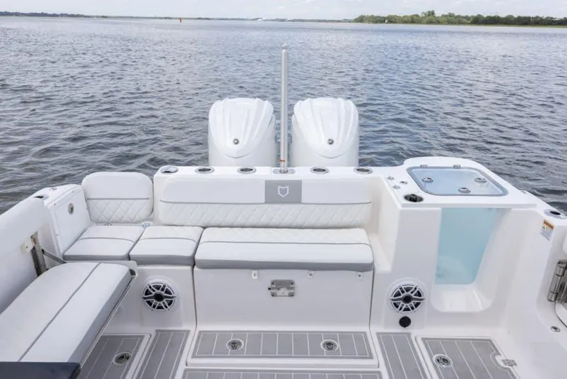 Slide: The Image of Manufacturer Provided Image: 2025 Sea Fox 288 Traveler boat interior with seating and twin engines on a calm lake. - 11