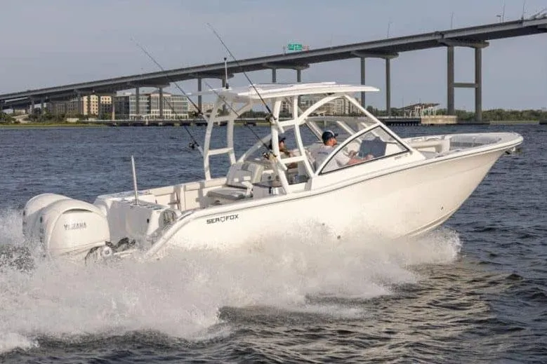Slide: The Image of Manufacturer Provided Image: 2025 Sea Fox 288 Traveler boat cruising under a bridge on open water. - 2