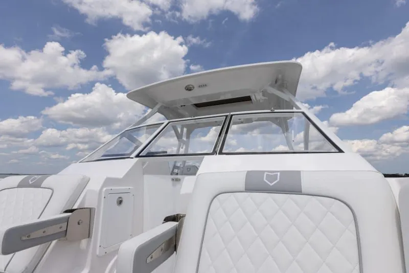 Slide: The Image of Manufacturer Provided Image: 2025 Sea Fox 288 Traveler boat with sleek design and comfortable seating under a cloudy sky. - 5