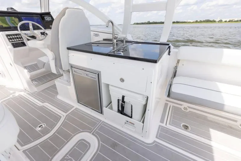 Slide: The Image of Manufacturer Provided Image: 2025 Sea Fox 288 Traveler boat interior with sleek kitchen and steering area. - 9