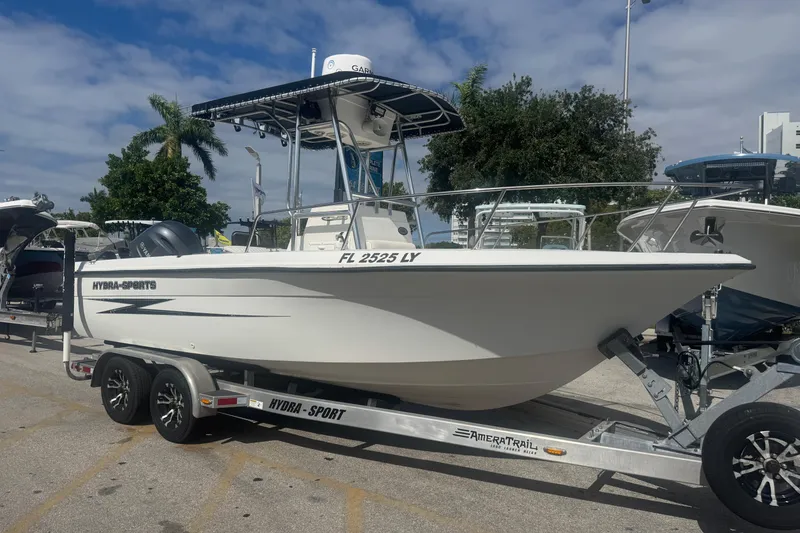 The Image of 2002 Hydra-Sports 212 CC boat on trailer, parked outdoors under a cloudy sky. - 0