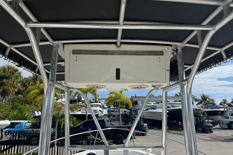 Slide: The Image of 2002 Hydra-Sports 212 CC boat with T-top frame and electronics box, docked at marina. - 10