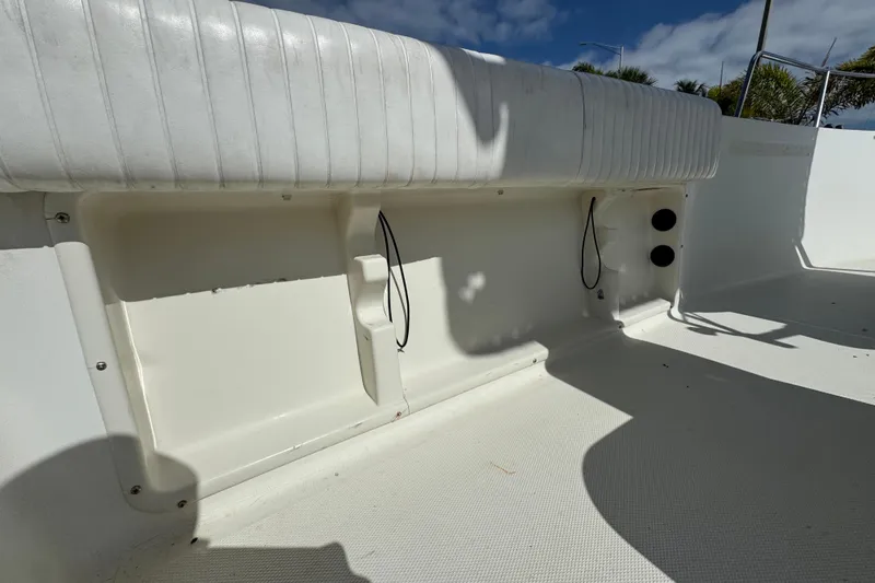 Slide: The Image of 2002 Hydra-Sports 212 CC boat interior with white seating and storage compartments. - 11