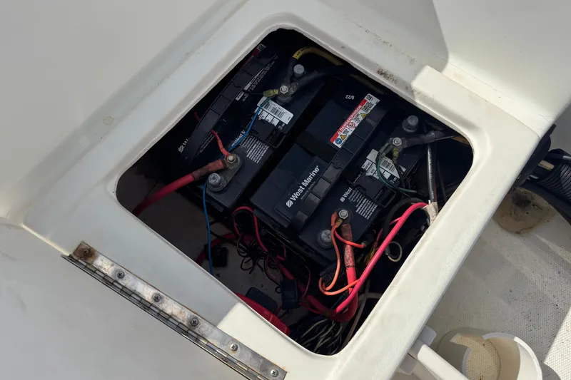 Slide: The Image of Battery compartment of a 2002 Hydra-Sports 212 CC boat with visible wiring. - 13