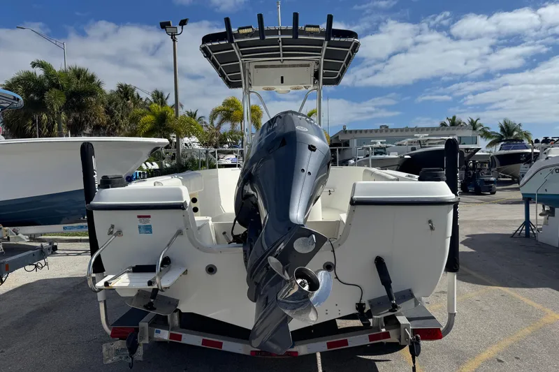 Slide: The Image of 2002 Hydra-Sports 212 CC boat on trailer, outboard motor, sunny marina setting. - 14