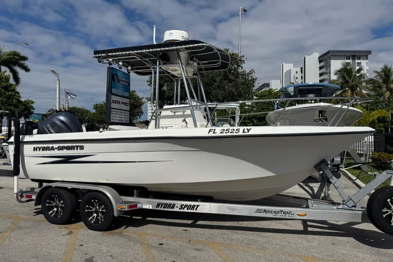 The Image of 2002 Hydra-Sports 212 CC boat on trailer, parked outdoors under cloudy sky. - 2