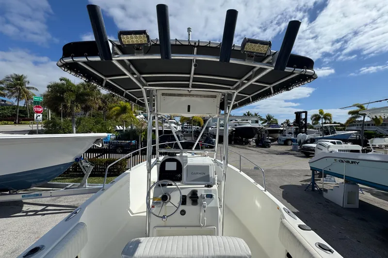 Slide: The Image of 2002 Hydra-Sports 212 CC boat with T-top and Garmin navigation, parked outdoors. - 6