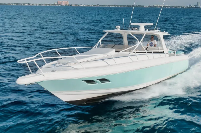 Slide: The Image of 2018 Intrepid 390 Sport Yacht cruising on open water, showcasing sleek design and performance. - 1