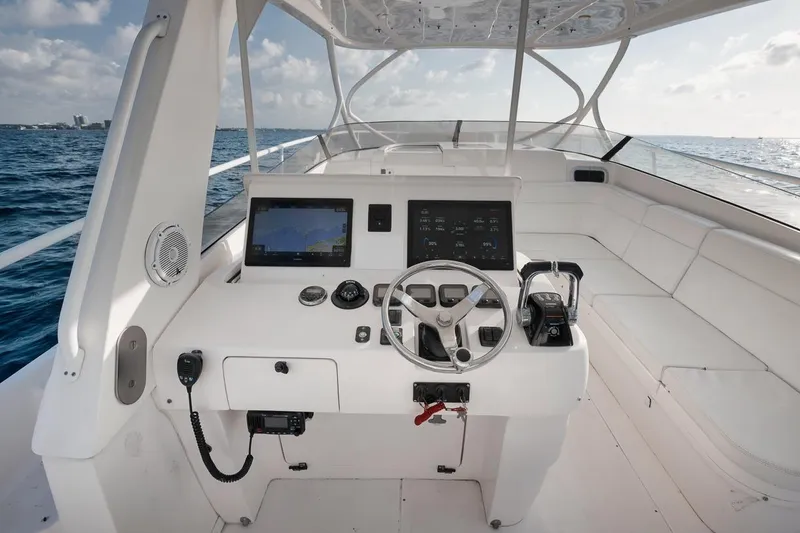 Slide: The Image of 2018 Intrepid 390 Sport Yacht helm with navigation screens and ocean view. - 29