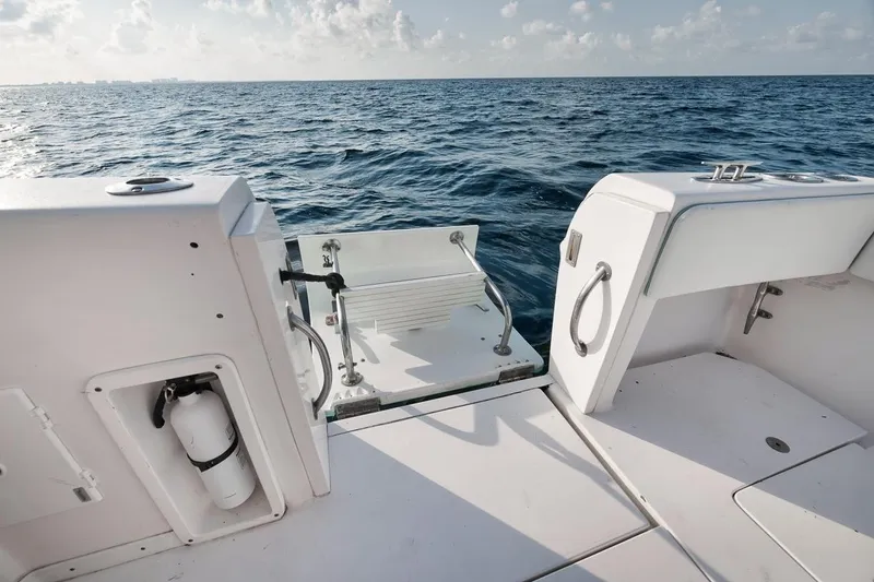 Slide: The Image of Interior of a 2008 Intrepid 390 Sport Yacht with turquoise cabinetry and cozy sleeping area. - 46
