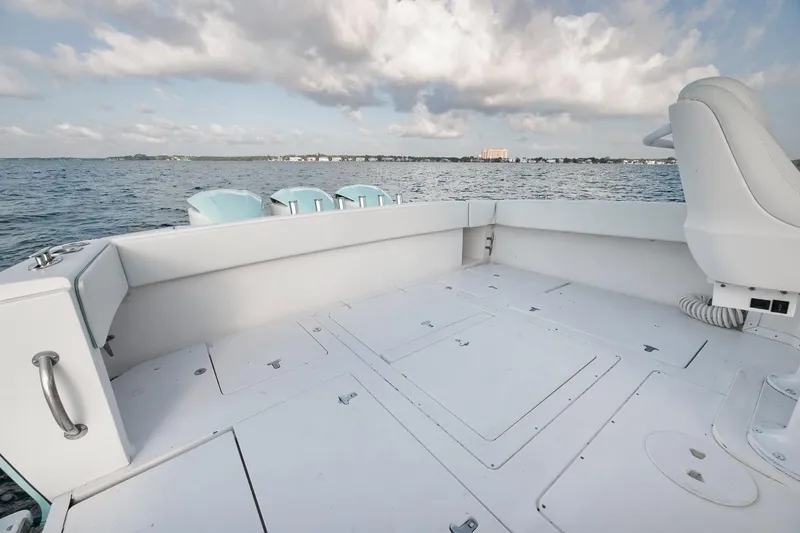 Slide: The Image of Interior of 2008 Intrepid 390 Sport Yacht with turquoise cabinets and tan leather seating. - 48