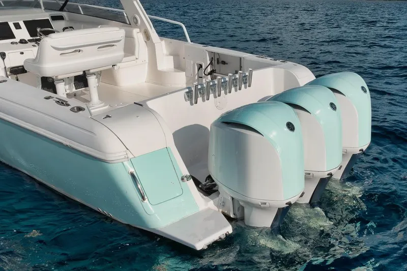 Slide: The Image of Triple outboard engines on a 2018 Intrepid 390 Sport Yacht, cruising on open water. - 56