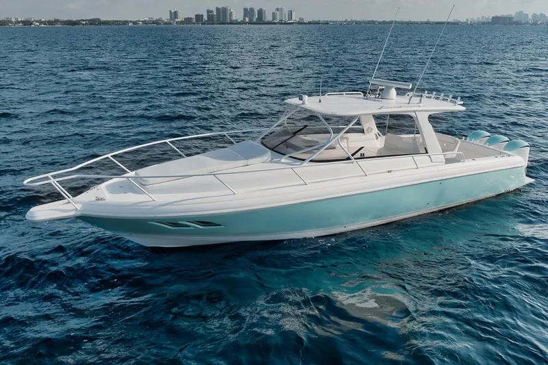 The Image of 2018 Intrepid 390 Sport Yacht cruising on open water, city skyline in background. - 0