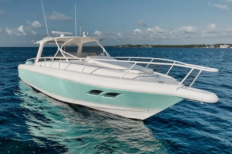 Slide: The Image of 2018 Intrepid 390 Sport Yacht cruising on clear blue ocean waters. - 10
