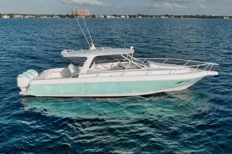 Slide: The Image of 2018 Intrepid 390 Sport Yacht cruising on clear blue ocean waters. - 12