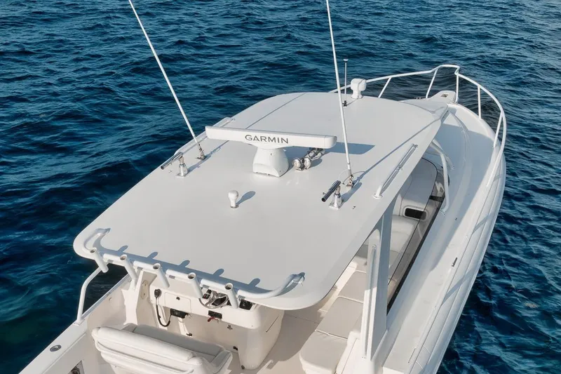 Slide: The Image of 2018 Intrepid 390 Sport Yacht on blue ocean waters, featuring Garmin equipment. - 13