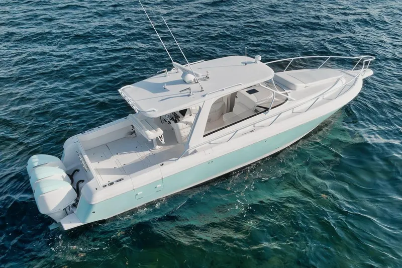 Slide: The Image of 2018 Intrepid 390 Sport Yacht cruising on clear blue water. - 14