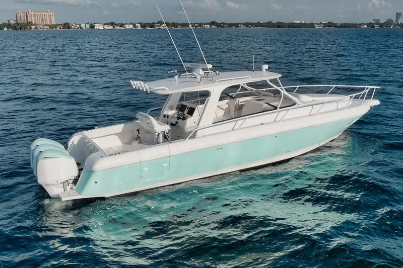 Slide: The Image of 2018 Intrepid 390 Sport Yacht cruising on clear blue ocean waters. - 16