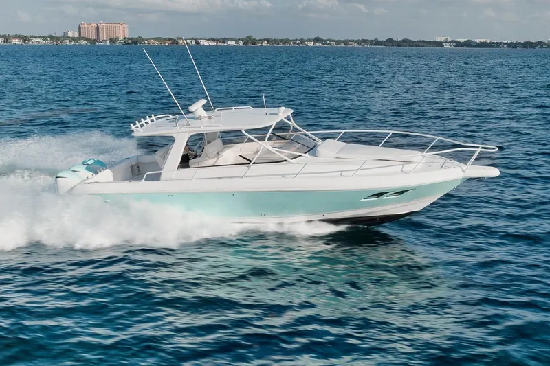 Slide: The Image of 2018 Intrepid 390 Sport Yacht cruising on open water. - 18