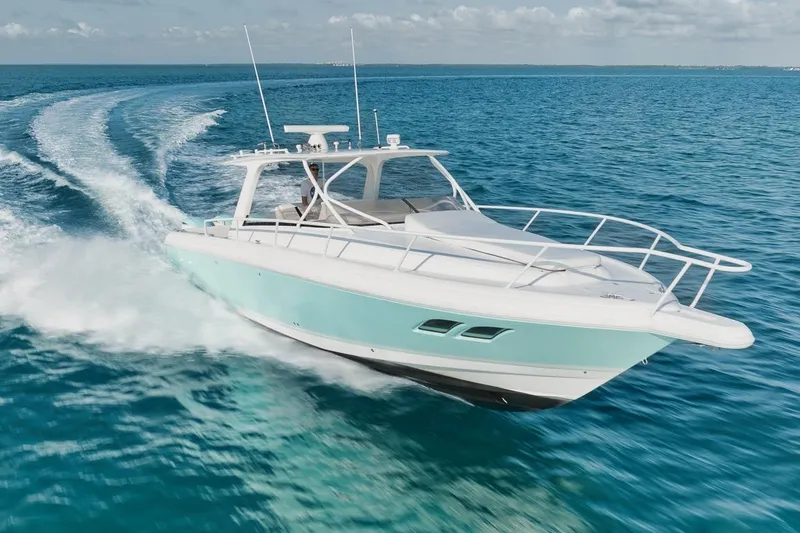 Slide: The Image of 2018 Intrepid 390 Sport Yacht cruising on clear blue ocean waters. - 19