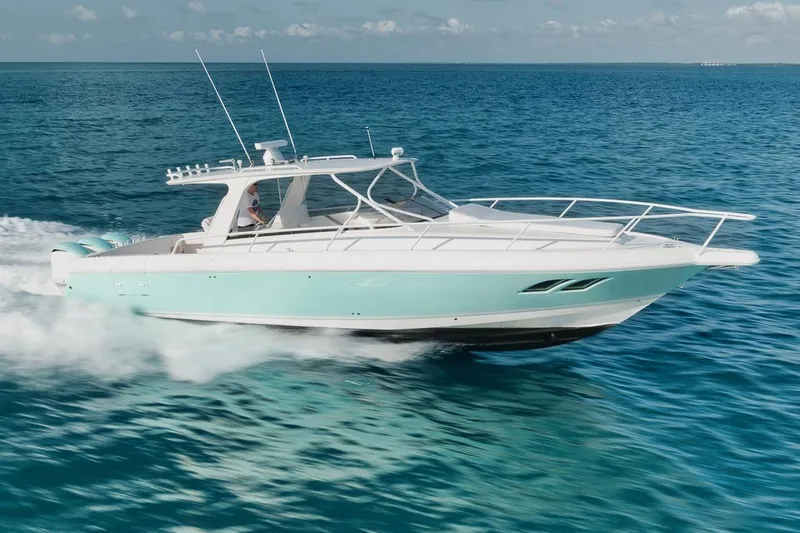 Slide: The Image of 2018 Intrepid 390 Sport Yacht cruising on clear blue ocean waters. - 20