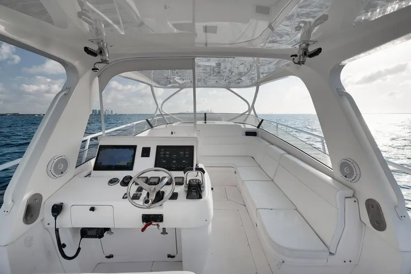 Slide: The Image of 2018 Intrepid 390 Sport Yacht interior with helm, seating, and ocean view. - 28