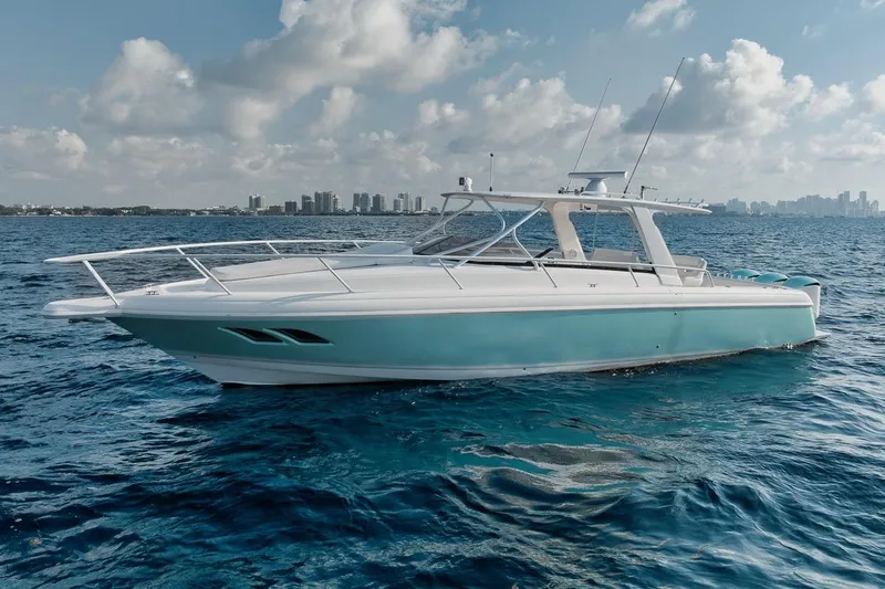 Slide: The Image of 2018 Intrepid 390 Sport Yacht cruising on open water under a partly cloudy sky. - 3