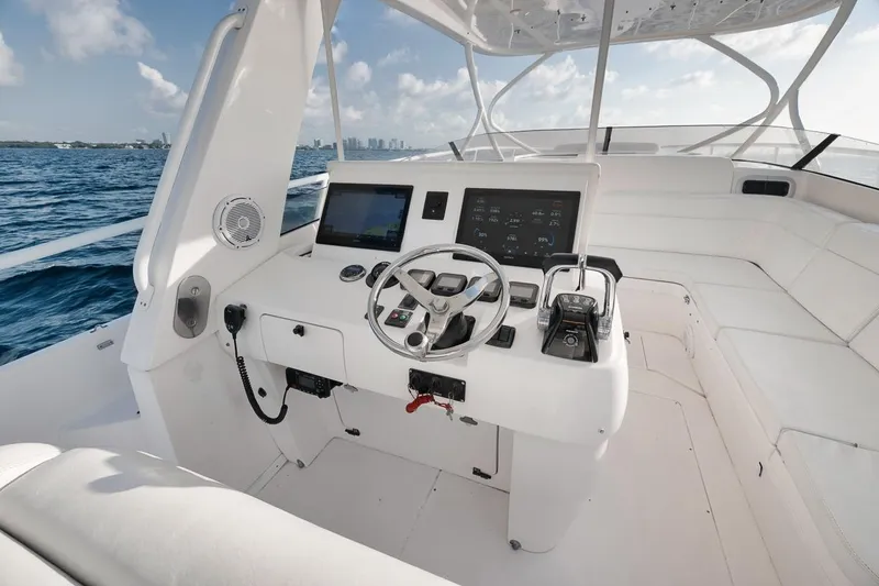 Slide: The Image of Cockpit of 2018 Intrepid 390 Sport Yacht with steering wheel and navigation controls. - 30
