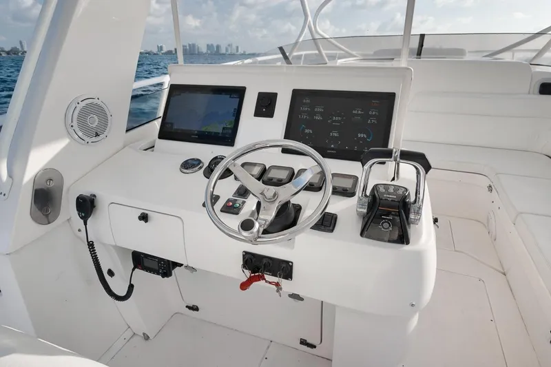 Slide: The Image of Helm of 2018 Intrepid 390 Sport Yacht with modern navigation displays and controls. - 31