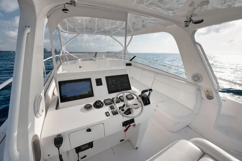 Slide: The Image of 2018 Intrepid 390 Sport Yacht helm with modern navigation systems on open sea. - 32