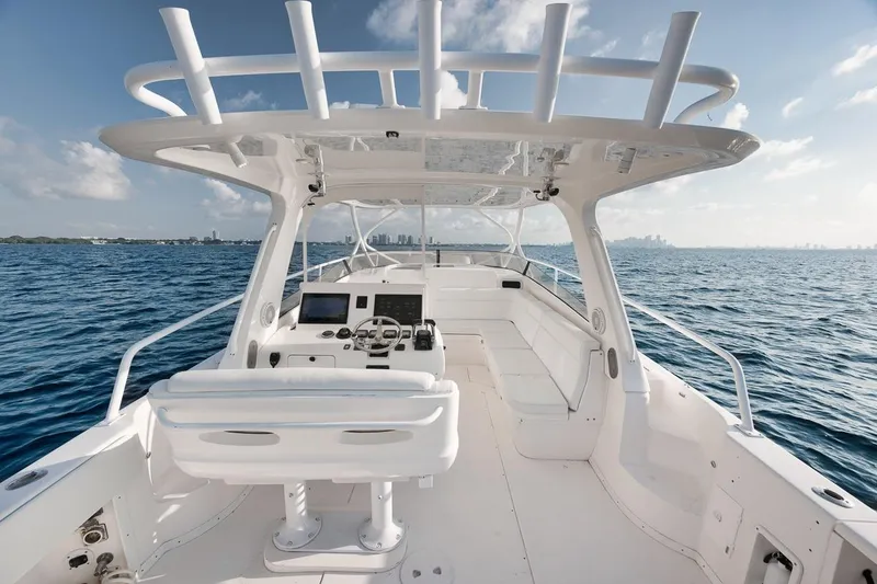 Slide: The Image of 2018 Intrepid 390 Sport Yacht on open water, featuring sleek design and modern cockpit. - 33