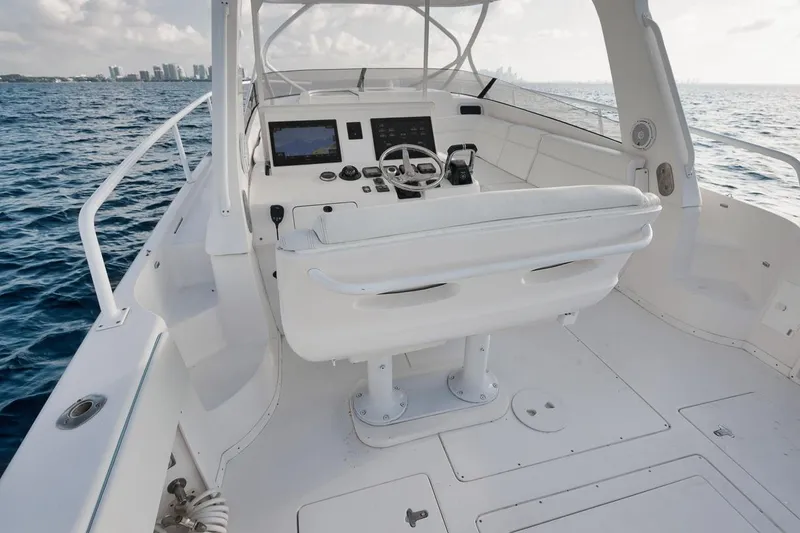 Slide: The Image of 2018 Intrepid 390 Sport Yacht helm with ocean view and modern controls. - 36