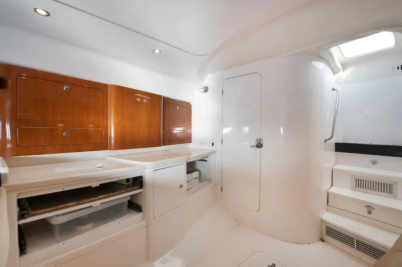 Slide: The Image of 2018 Intrepid 390 Sport Yacht interior with sleek white cabinetry and wooden accents. - 37