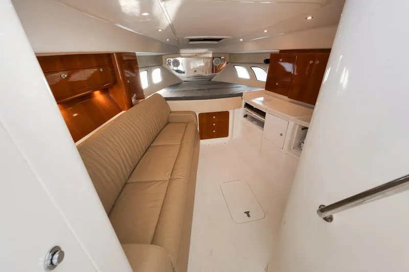 Slide: The Image of Interior of 2018 Intrepid 390 Sport Yacht with beige sofa and wooden cabinetry. - 38