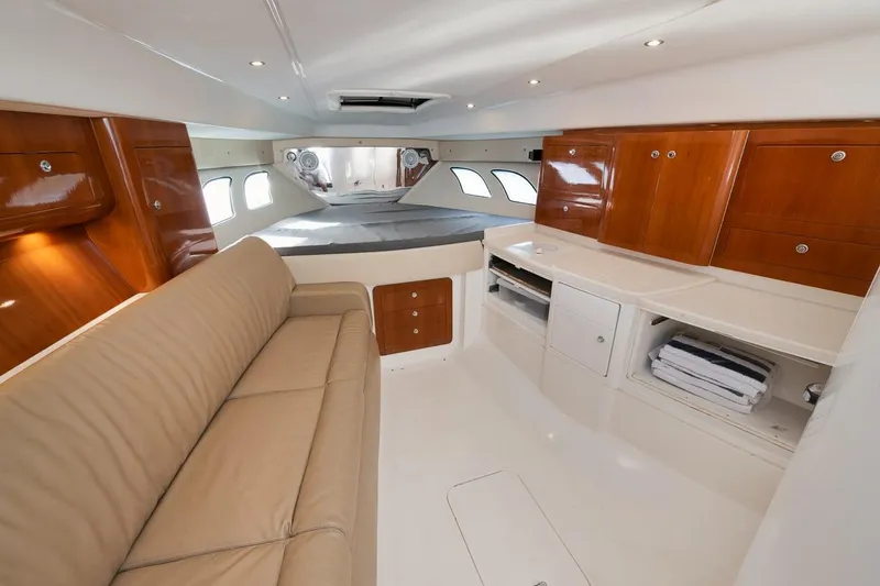 Slide: The Image of Interior of 2018 Intrepid 390 Sport Yacht with beige sofa and wooden cabinetry. - 39