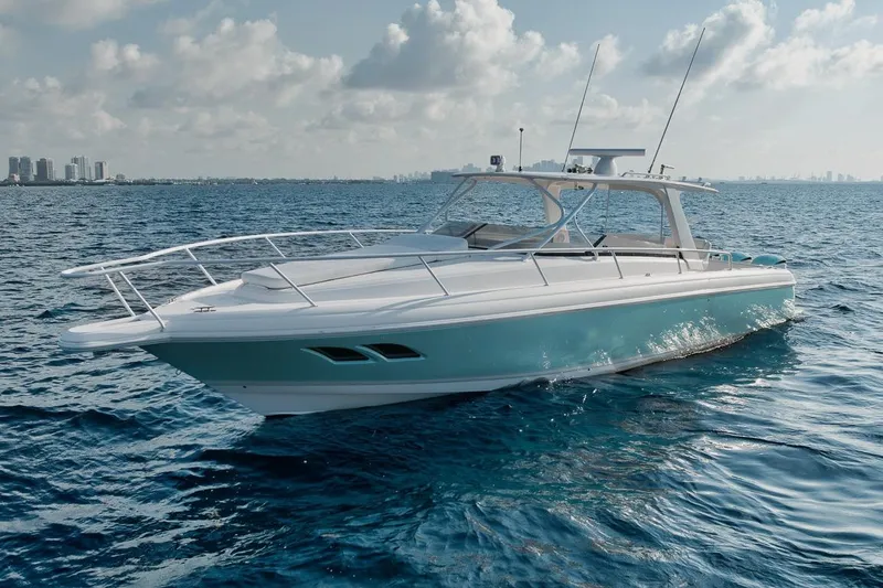 Slide: The Image of 2018 Intrepid 390 Sport Yacht cruising on open water under a partly cloudy sky. - 4