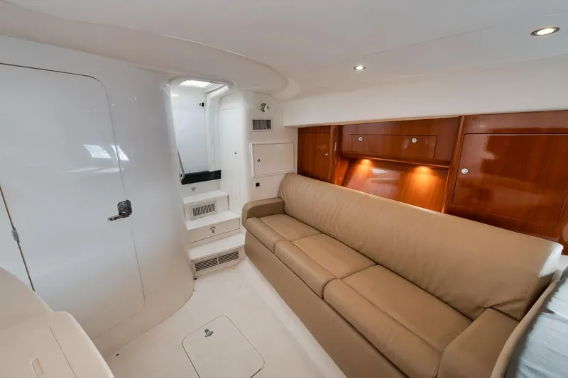 Slide: The Image of Interior of 2018 Intrepid 390 Sport Yacht with beige sofa and wooden cabinets. - 41
