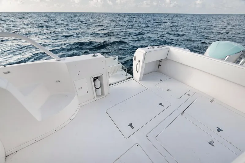 Slide: The Image of 2018 Intrepid 390 Sport Yacht deck overlooking the ocean, showcasing spacious design and sleek features. - 47