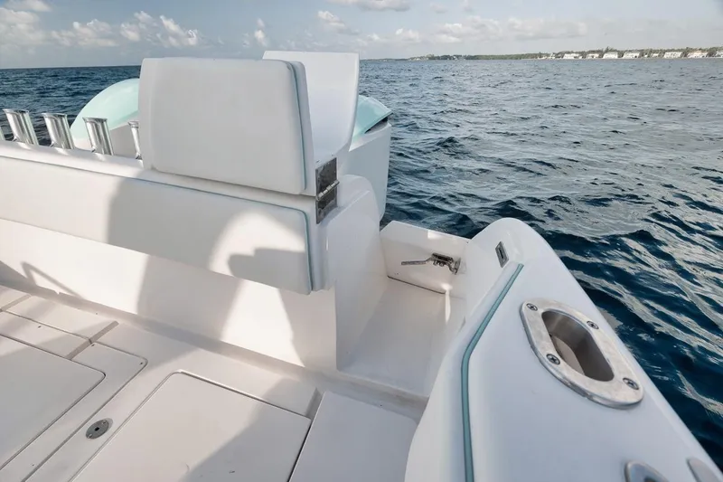 Slide: The Image of 2018 Intrepid 390 Sport Yacht, white seating, ocean view, sunny day, luxury boating experience. - 49