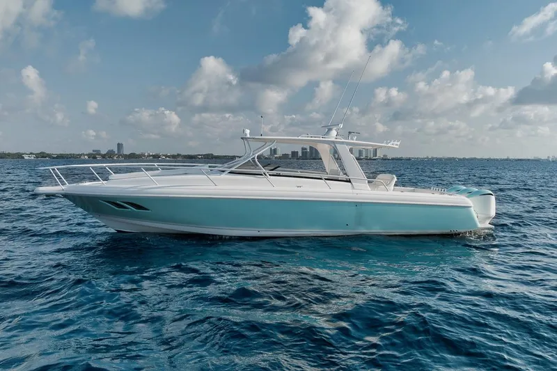 Slide: The Image of 2018 Intrepid 390 Sport Yacht cruising on open water under a partly cloudy sky. - 5