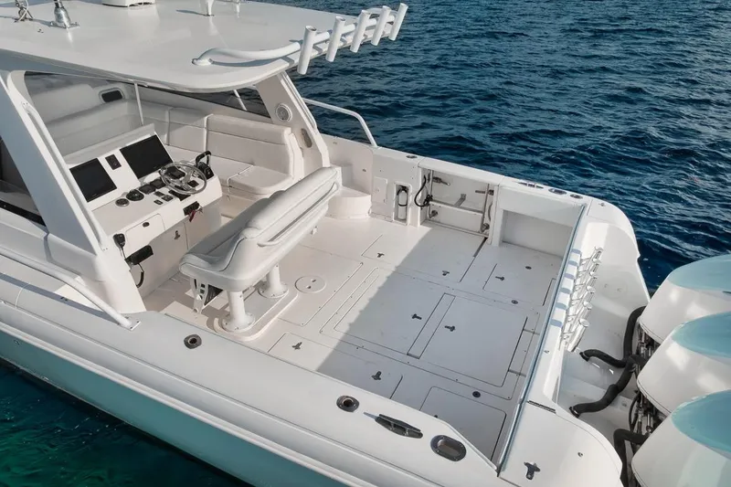 Slide: The Image of 2018 Intrepid 390 Sport Yacht with spacious deck and modern controls on open water. - 54