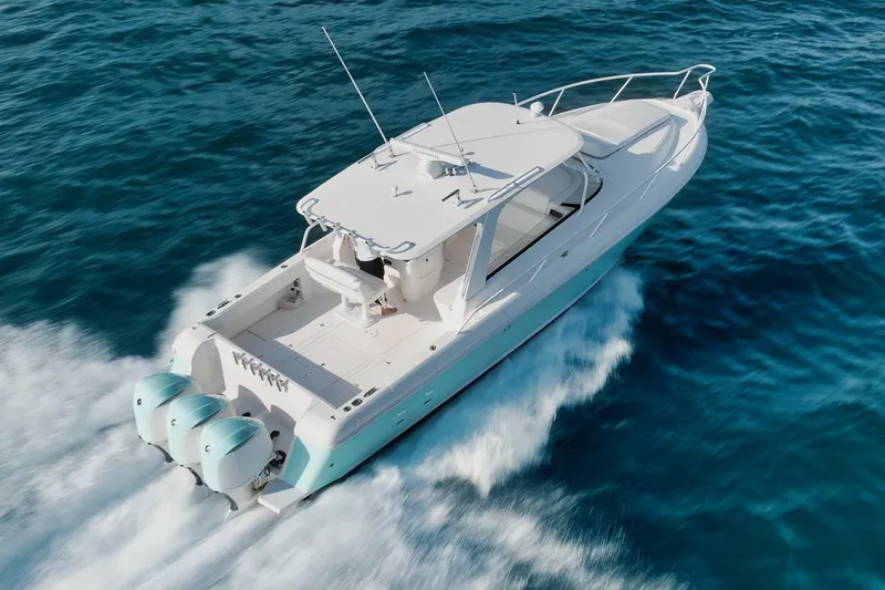 Slide: The Image of 2018 Intrepid 390 Sport Yacht cruising on open blue waters. - 57