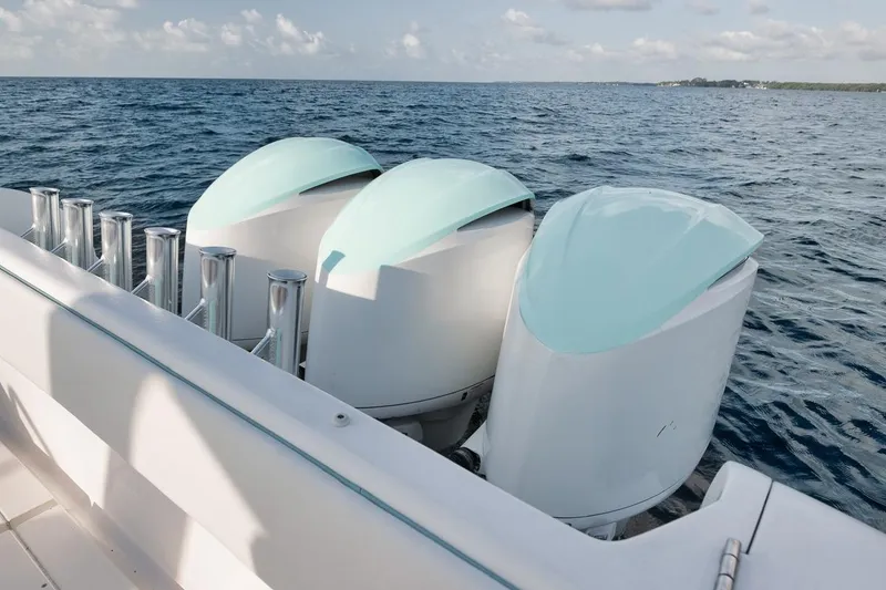 Slide: The Image of Triple outboard engines on a 2018 Intrepid 390 Sport Yacht, cruising on open water. - 59