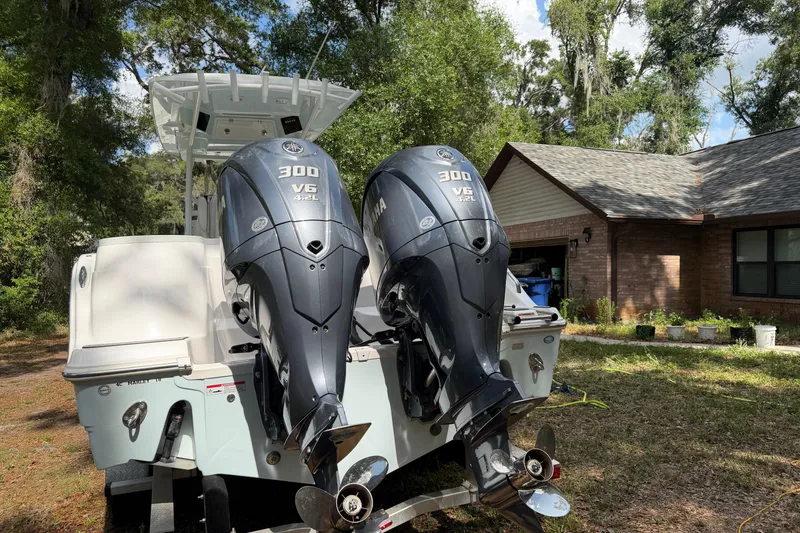 Slide: The Image of 2023 Sea Fox 288 Commander with dual Yamaha 300 V6 engines, parked outdoors. - 10