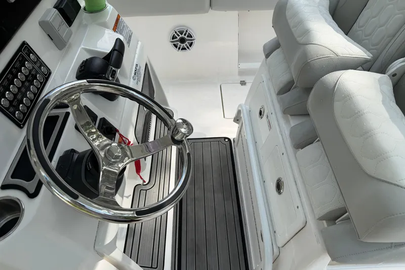 Slide: The Image of 2023 Sea Fox 288 Commander helm with steering wheel and cushioned seating. - 2